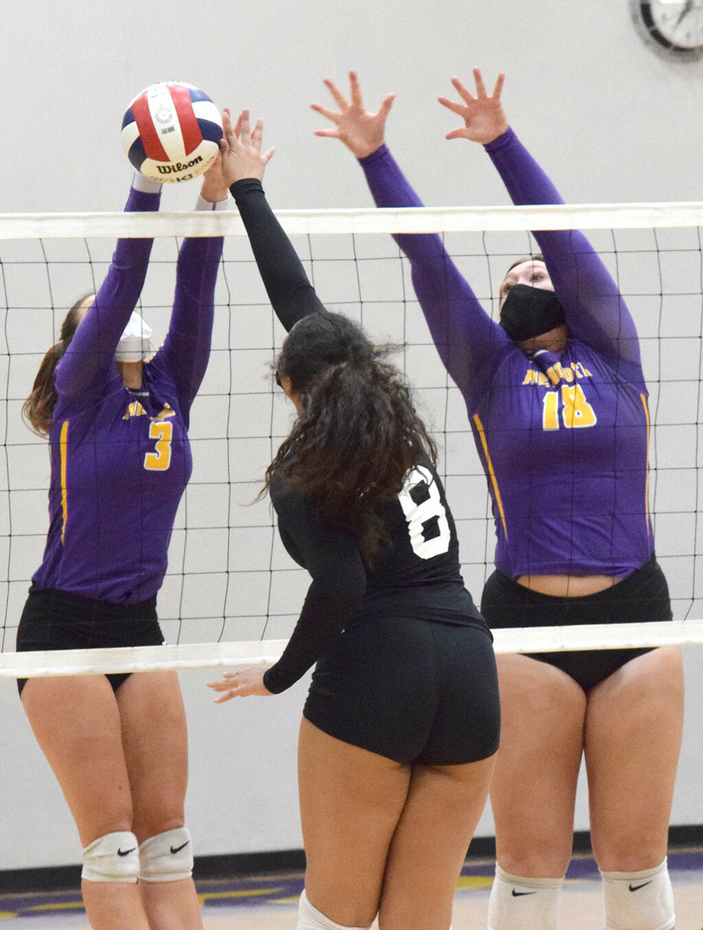 Mendota’s Ella Massey, left, gets a block off of a kill attempt by Christina Anyebuno of Rockford Christian while Jaelyn Fitzgerald assists on March 18 at the MHS gym. (Reporter photo)