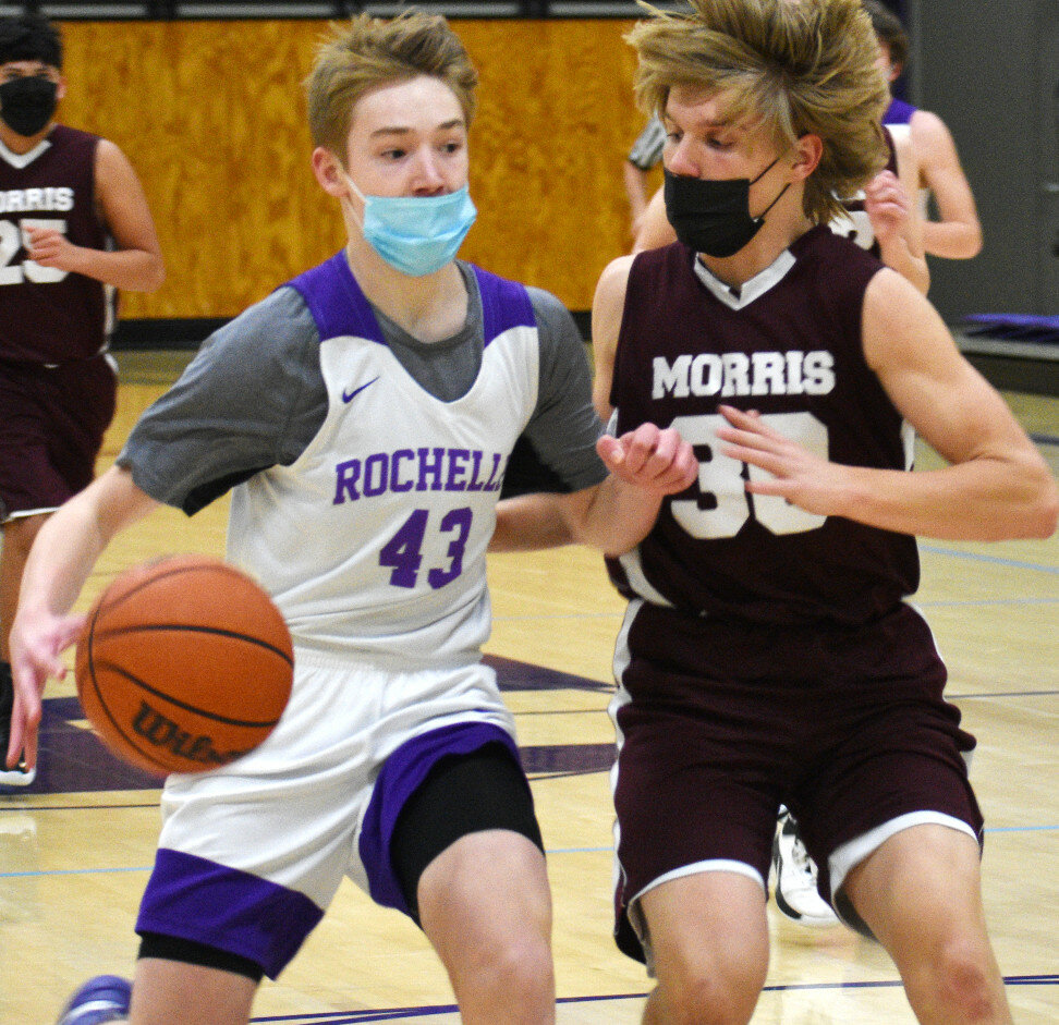Elijah Luxton drives against Morris defender Connor Mettille during the Rochelle Hub freshman basketball game Thursday evening. Luxton scored 15 points. (Photo by Russell Hodges)