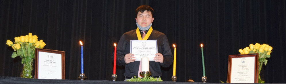 Ayden Theiss was among those who waited a year for the NHS induction at Rochelle Township High School held Monday night.