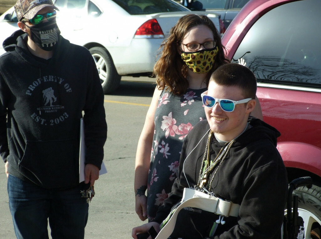 Gordon Woods / Journal — Clinton High School junior, Caleb Zook, seated wearing sun glasses, returned home on Thursday after a hospitalization in St. Louis.  Zook was seriously injured in an October 2020 car accident.
See the story next week in the Clinton Journal.