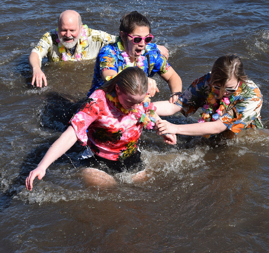 Participants from last year's Polar Plunge at Lake Mendota react to the frigid water.