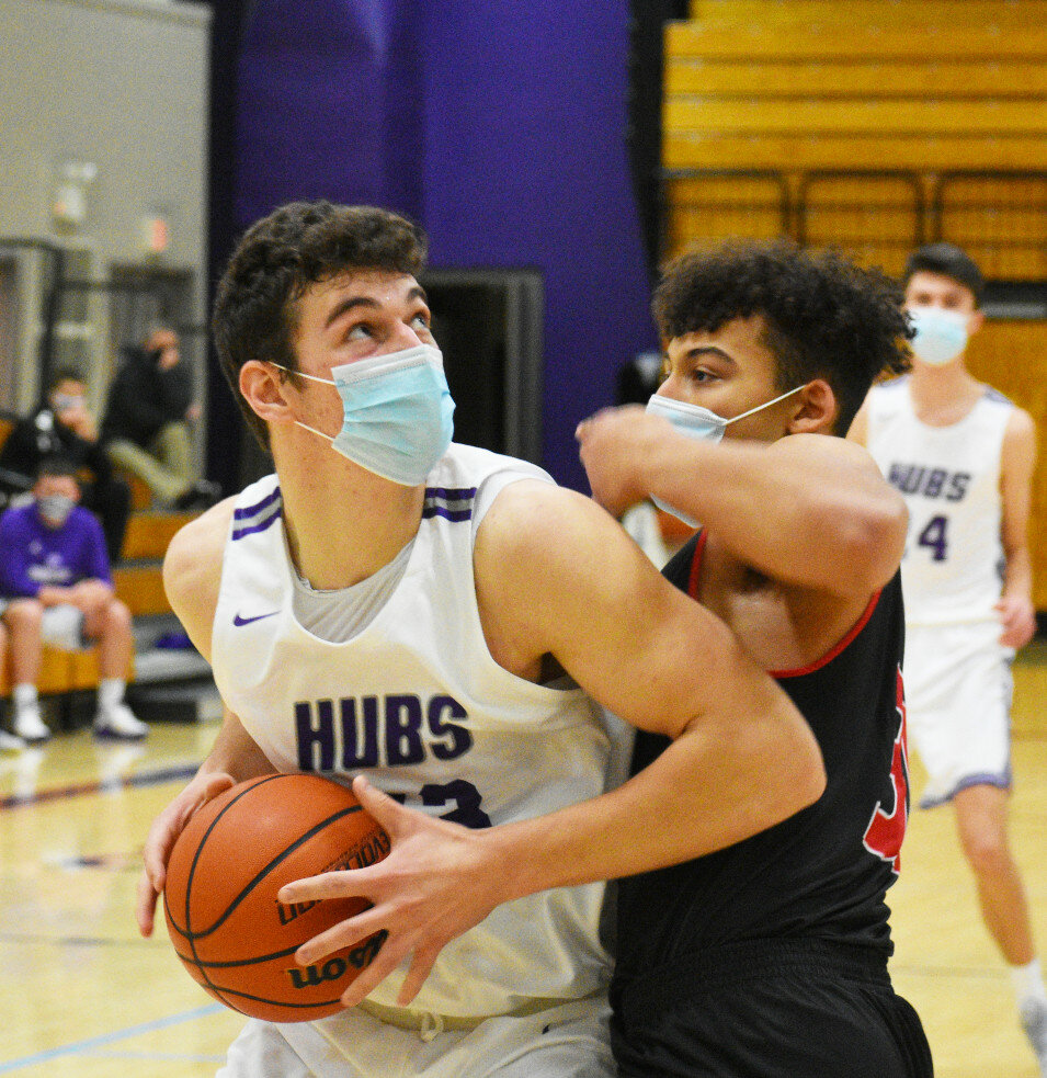 Junior Zach Sanford works down low while guarded by LaSalle-Peru’s Latrell Coulter during the Rochelle Hub varsity basketball game against the Cavaliers on Friday. Sanford scored 11 points in the loss. (Photo by Russell Hodges)