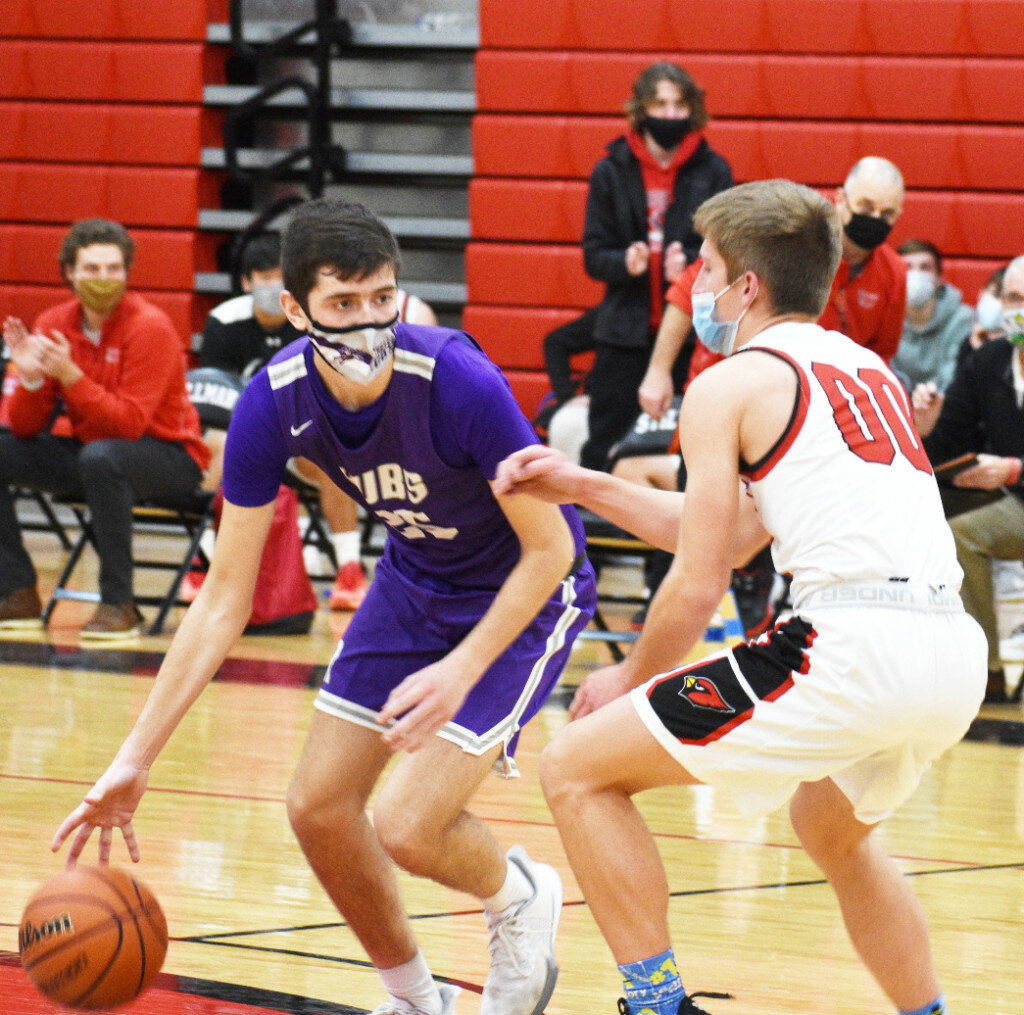 Junior Adam Kemp dribbles around Stillman Valley’s Micah Johnson during Rochelle’s varsity basketball game against the Cardinals on Friday. Kemp hit three 3-pointers and scored nine points for the Hubs. (Photo by Russell Hodges)