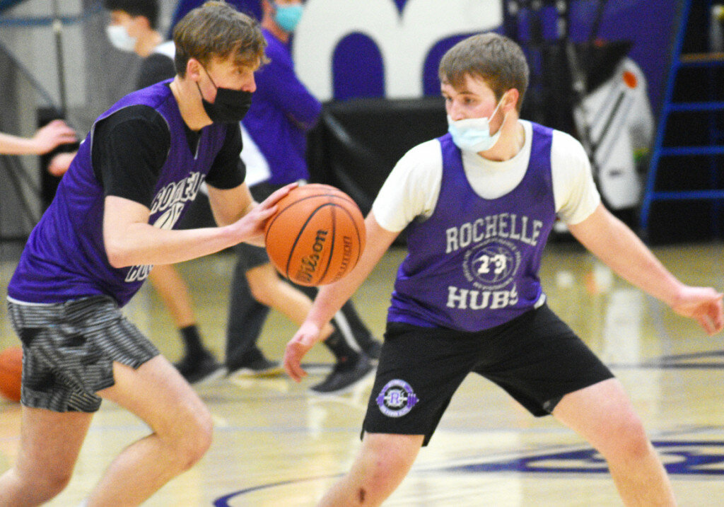Seniors Garrett Burdin and Spencer Warborg battle during Rochelle's basketball practice Wednesday evening. After two months away, high-risk sports like basketball were recently given new clearance to not only practice, but play games in regions that return to Phase 4. (Photo by Russell Hodges)