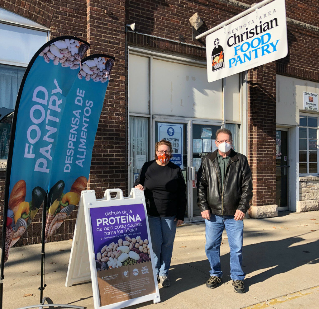 Tracy Cooper, Mendota Area Christian Food Pantry director, left, and assistant manager, Dan Carr, display a new sign and banner they received from University of Illinois Extension. (Photo contributed)