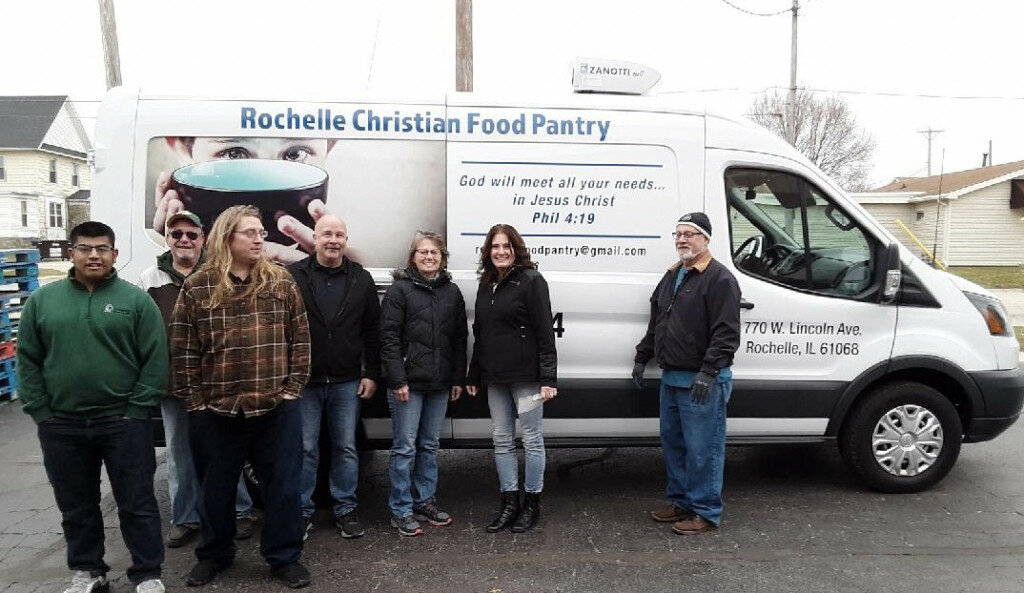 Above, Dave Drayna presents a new refrigerated van to Bill Vanstone, Rochelle Christian Food Pantry president, Cal Jacobs, pantry board member, and several other pantry volunteers.
