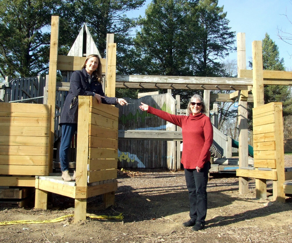 Gordon Woods / Journal — 
Claudine Wargel, left, hands Clinton Chamber of Commerce executive director Marian Brisard a donation to help continue work to renovate the Ultimate Play Space, located in Kiwanis Park.  They stand in an area that already has been replaced.