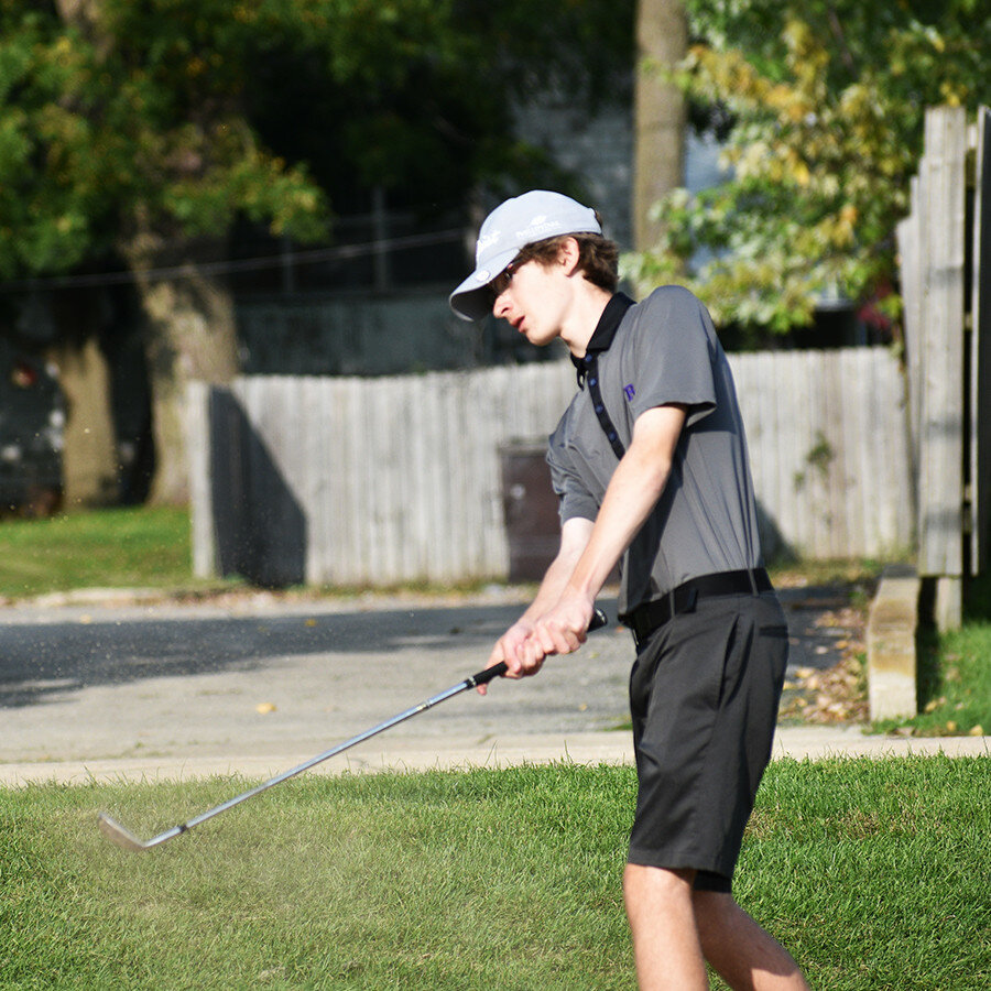 Sophomore Damen Harrington clears the bunker during match play earlier this season. After playing football for four years, Harrington has found a role with the varsity golf team after trying out for the team as a freshman in 2019. (Photo by Russell Hodges)