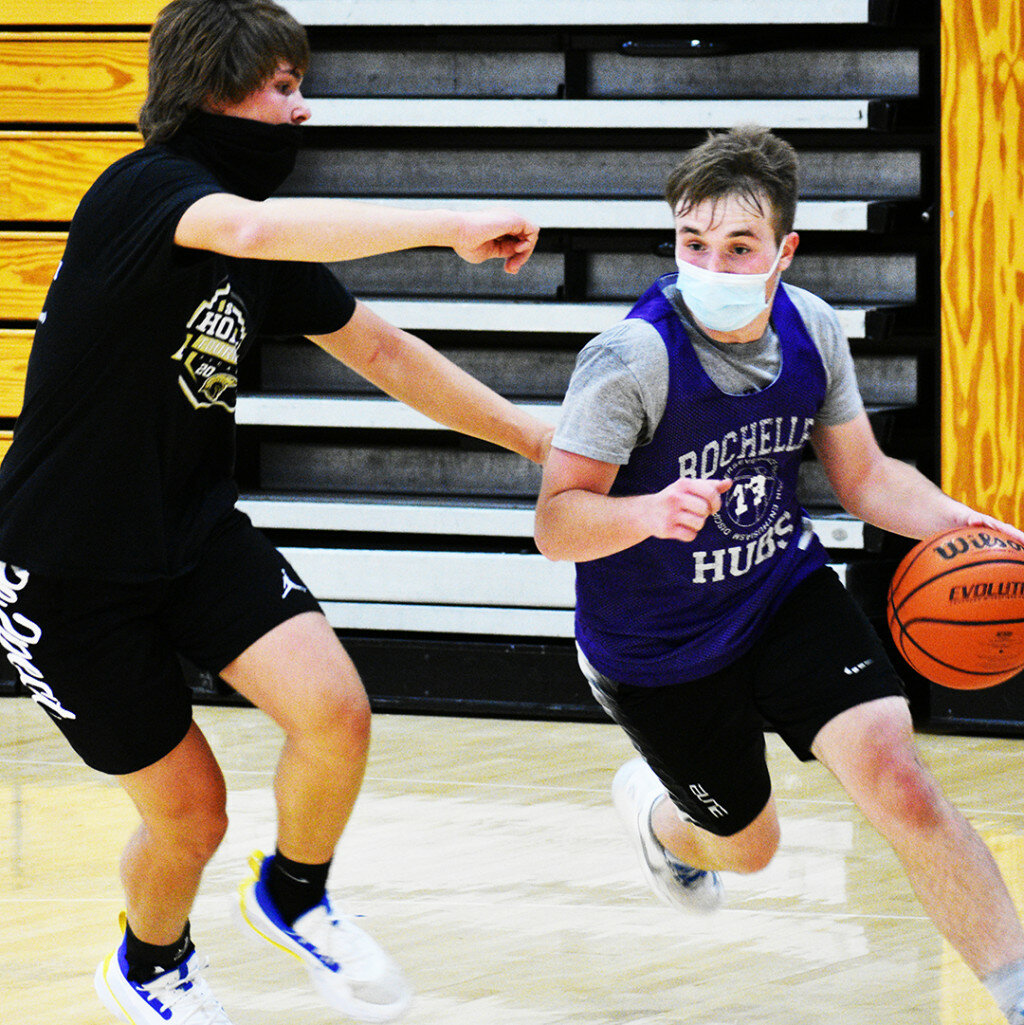 Hub basketball players Spencer Warborg (right) and Tanner Lager (left) battle during one of the team's fall contact days this past week. Below, sophomore Torrin Nantz brings the ball up the court during a Lady Hub intrasquad scrimmage. (Photos by Russell Hodges)