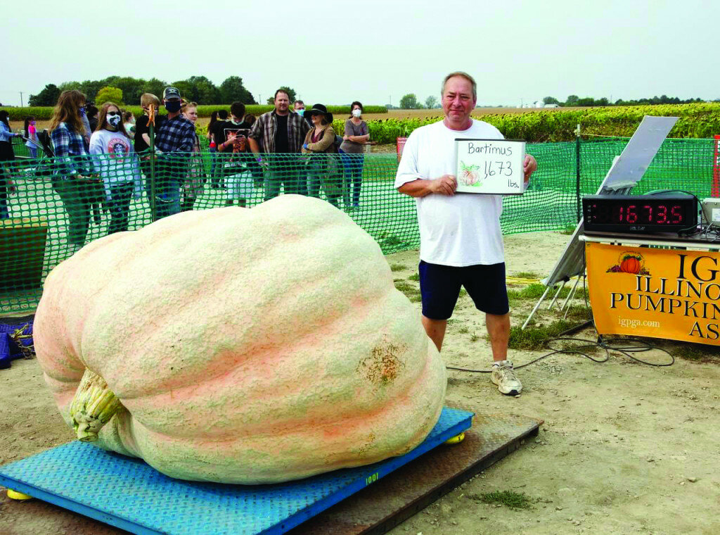 Courtesy of Gail’s Pumpkin Patch — 
Henry Bartimus with his 1,673-pound pumpkin, which will be on display at Gail’s Pumpkin Patch on Sunday.  Henry’s pumpkin-growing effort this season is the 5th largest ever grown in Illinois.