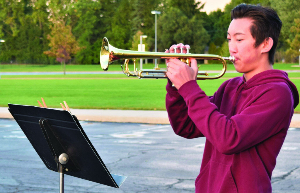 Rochelle Township High School Hub Marching Band member Evin Odle practices his piece on the trumpet for the Saturday Life Your Voice performance.