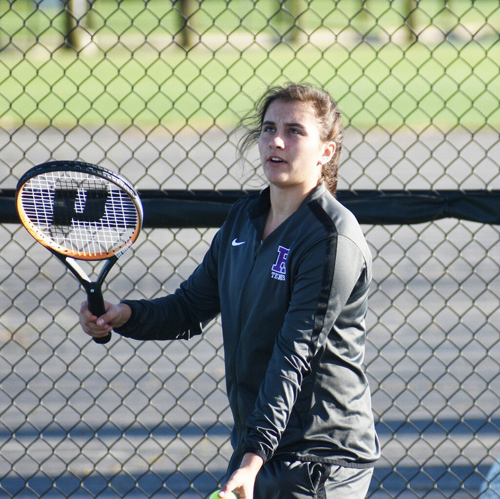 Junior Sylvia Hasz prepares a serve for the Lady Hubs. Hasz was one of six players to win singles matches against Morris on Saturday. (Photo by Russell Hodges)