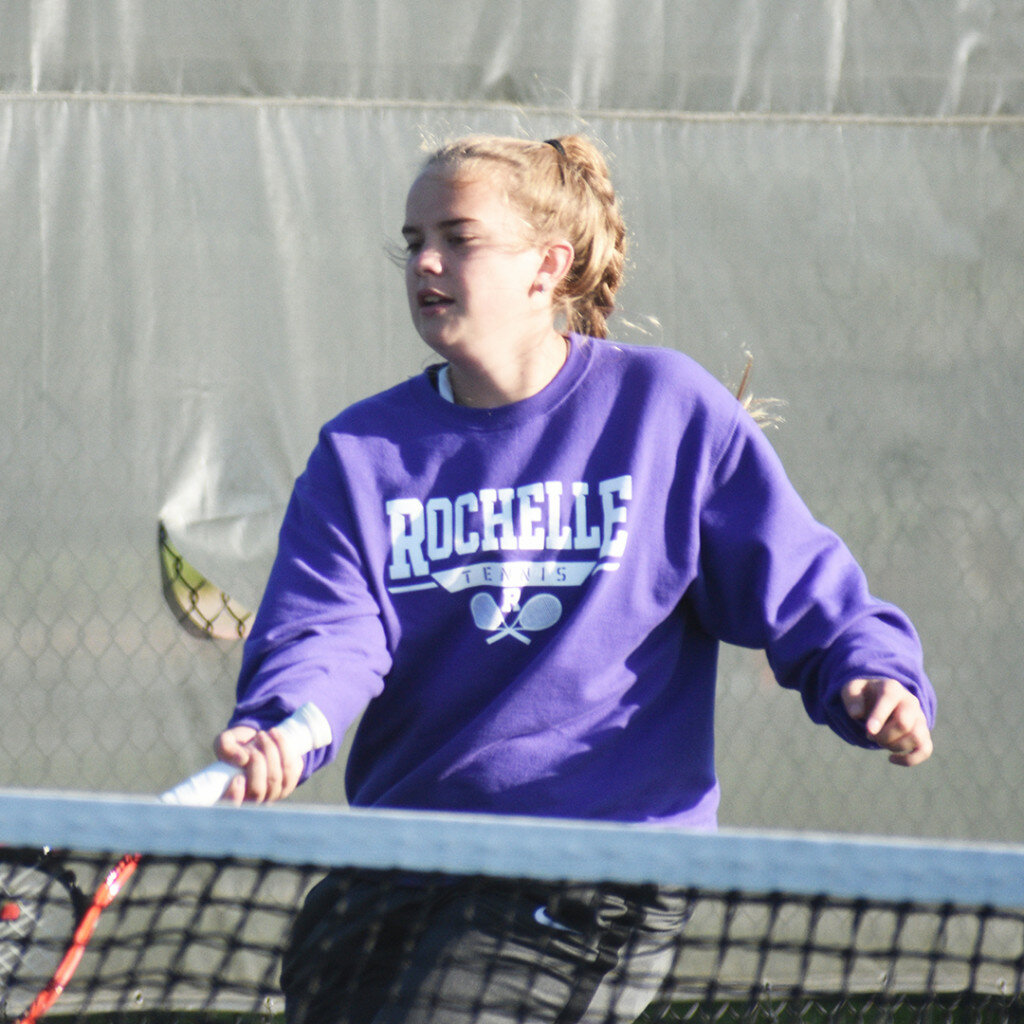 Junior Ashley Knight extends for a soft shot during Rochelle’s tennis match against Rockford Christian on Monday. (Photo by Russell Hodges)
