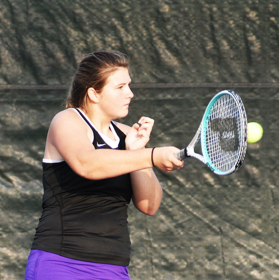 Senior Sawyer McGee goes to her forehand during Rochelle's tennis match against Guilford on Wednesday. (Photo by Russell Hodges)