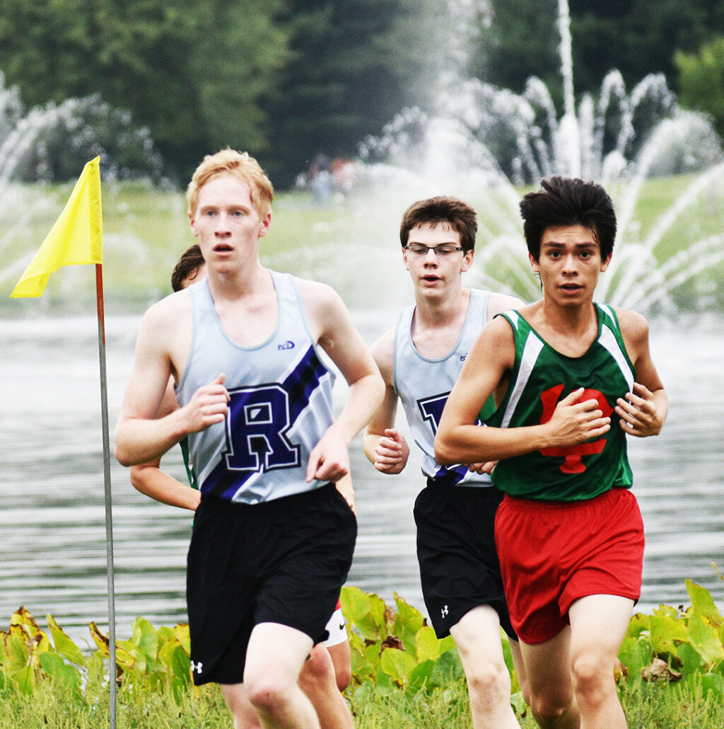 Juniors Max Orlikowski (left) and Peter Forsberg (middle) make the turn at Baker Lake Park during Rochelle's cross country race against LaSalle-Peru on Friday. (Photo by Russell Hodges)