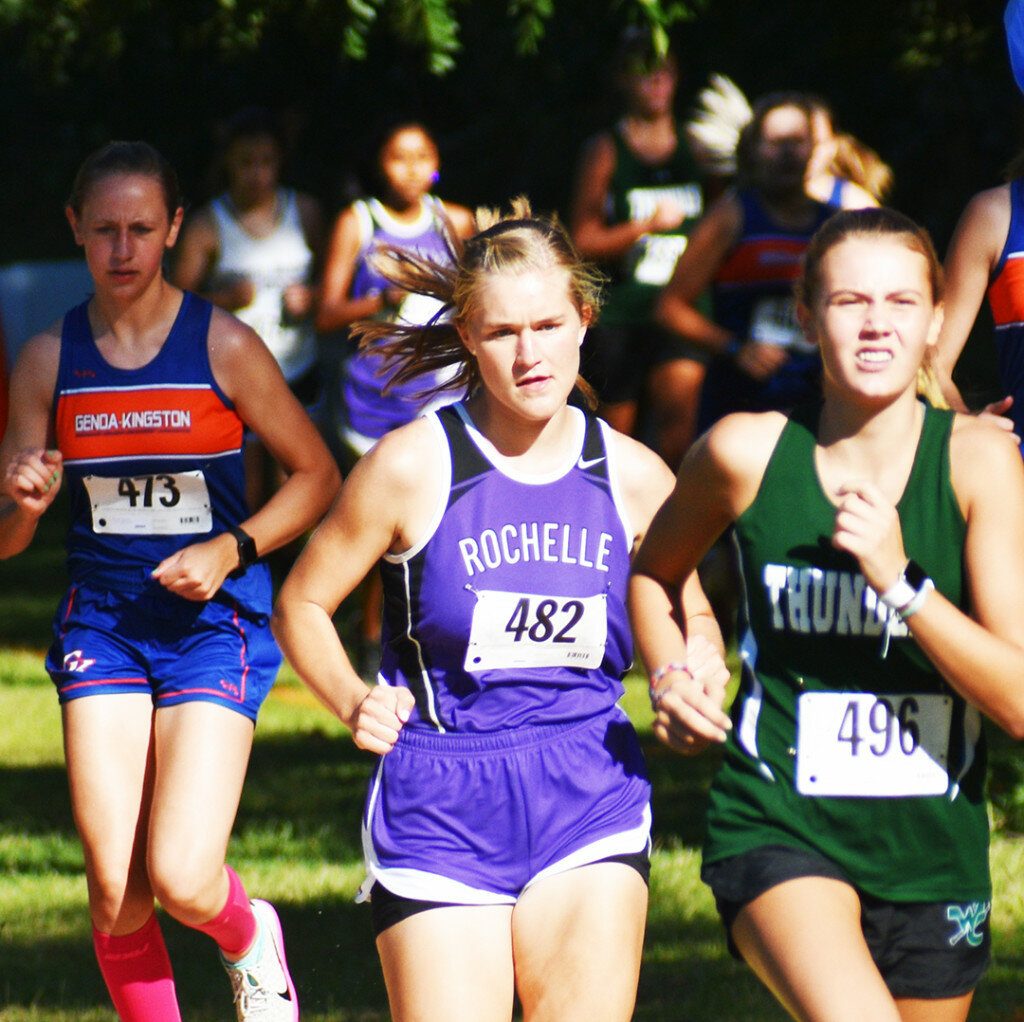Junior Sara Johnson pushes the pack forward during the varsity girls cross country race at Walcamp Park on Thursday. Johnson finished first overall, the first win of her high school career. (Photo by Russell Hodges)