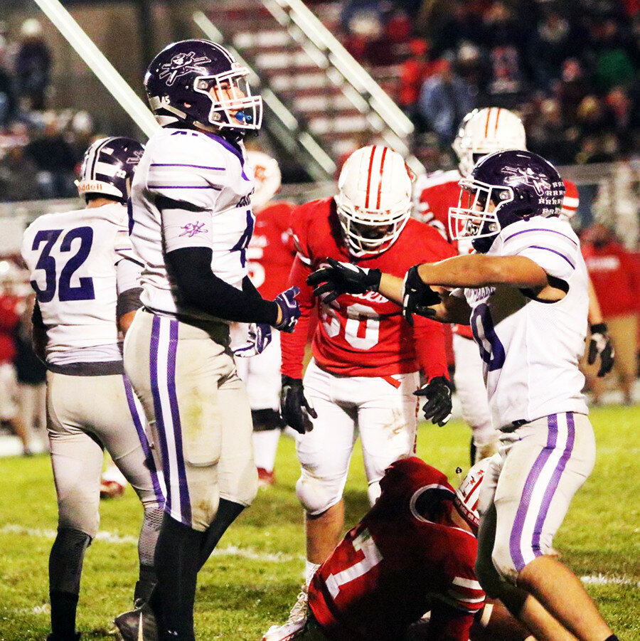 Rising seniors Ethan Albers (left) and Michael Schlenbecker (right) celebrate a sack against the Ottawa Pirates during Rochelle’s season-finale this past fall. (Photo by Marcy DeLille)