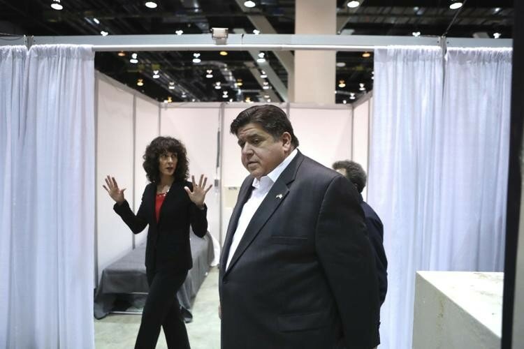 Illinois Gov. J.B. Pritzker tours Hall C Unit 1 of the COVID-19 alternate site at McCormick Place in Chicago on Friday, April 3, 2020. Hall C is planned to have 500 beds. In the background is Christina Bratis, clinical chief of staff of the facility.
 — Chris Sweda/Chicago Tribune via AP, Pool