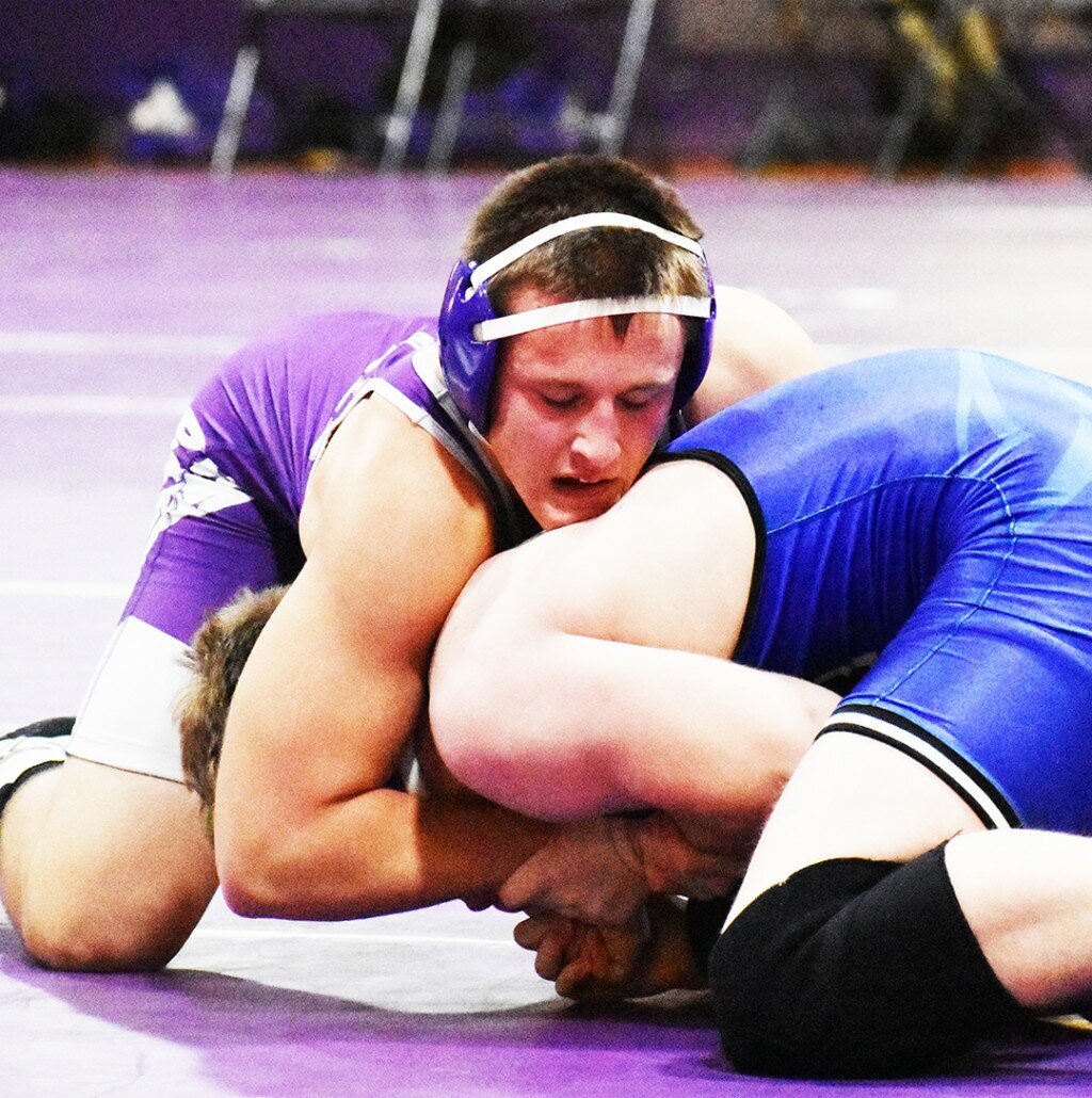 Rochelle junior Noah Messer tangles with an opponent during a varsity meet during the winter. Messer took home Academic All-State recognition from the IWCOA this season. (File photo by Russell Hodges)
