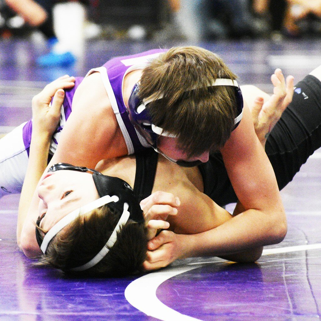 Eighth-grader Tommy Tourdot works for a pin during the IKWF Rochelle Sectional this past month. Tourdot is one of several Rochelle Wrestling Club members who will soon be competing at the high school level. (Photo by Russell Hodges)