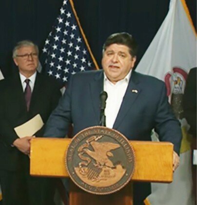Gov. JB Pritzker announces that the stay-at-home order in Illinois is being extended through April in Illinois during a news conference Tuesday in Chicago. All residents are now asked to remain at home except for essential business through April 30 to help slow the outbreak of COVID-19 in Illinois. (Credit: blueroomstream.com)