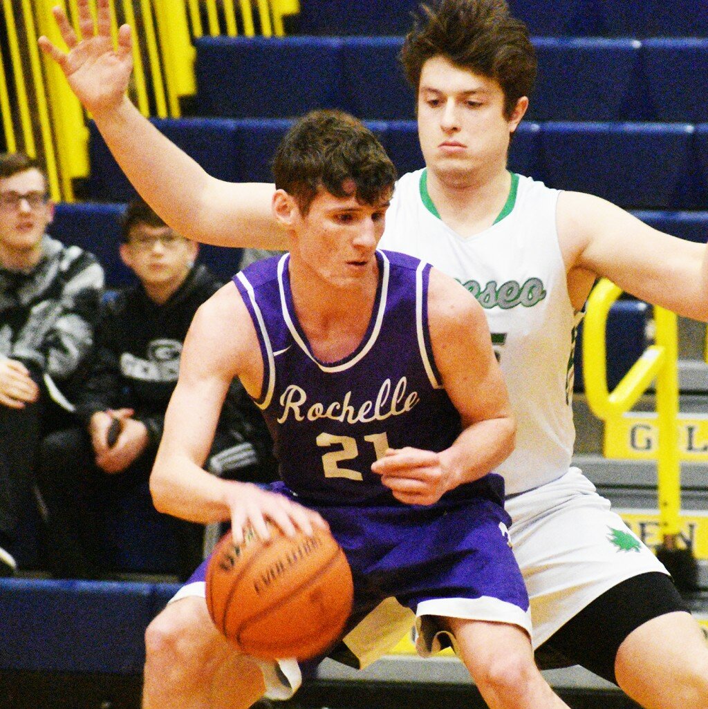 Senior Seth Gould battles in the post against Geneseo's PJ Moser during Rochelle's regional basketball title game on Friday. (Photo by Russell Hodges)