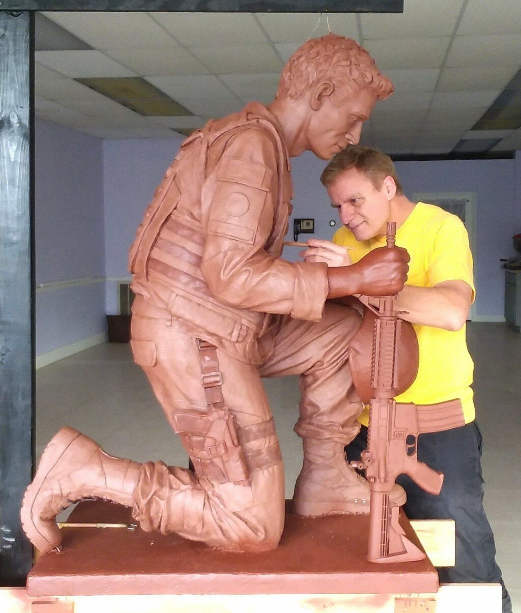 Fran Volz works on the clay model of the statue.