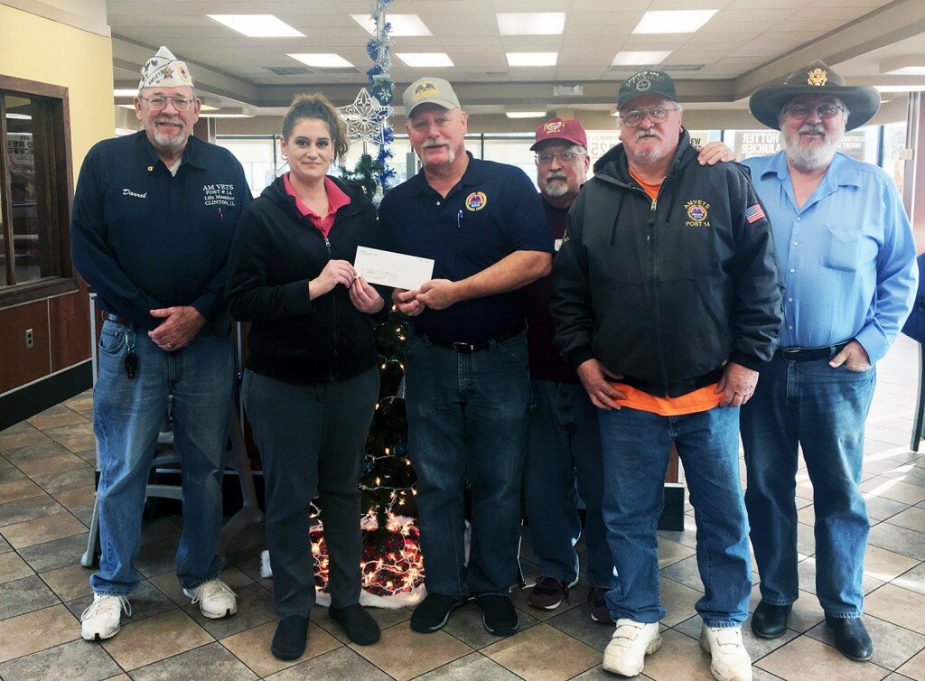 Submitted photo — Manager of Clinton Hardees, Amber Spurling, presents a $300 check to the AMVETS Post 14 Commander Ed Beck, along with several other Post 14 AMVETS, at the Clinton Hardees.