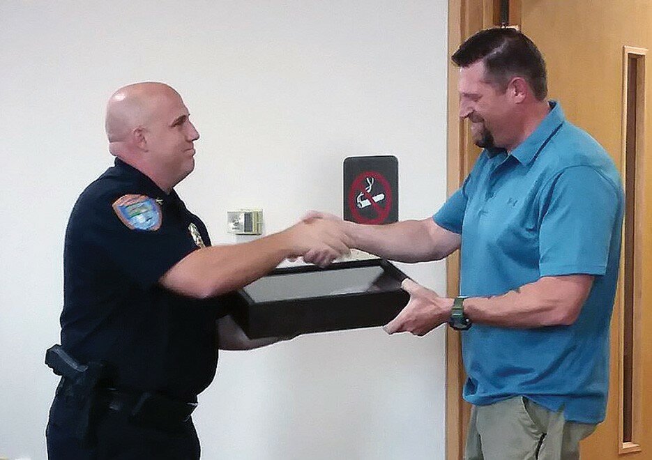 Gordon Woods / Journal — 
Above: Officer Joe Krasny takes his oath from city clerk Cheryl Van Valey.  Below:  Clinton Police Chief Ben Lowers recognized Sean Freytag as he retires from the department.