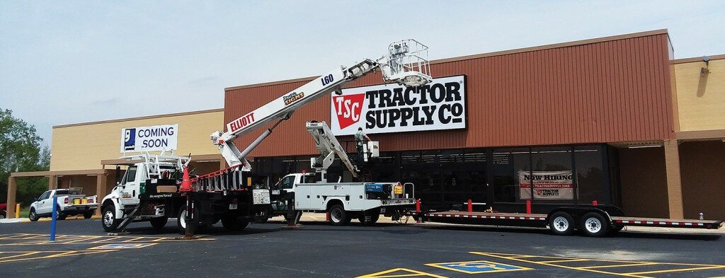 Gordon Woods / Journal — Contractors on Tuesday installed the building sign for the new Tractor Supply Company store.  TSC will share the building with Goodwill Industries.  Both stores are scheduled to open this summer.