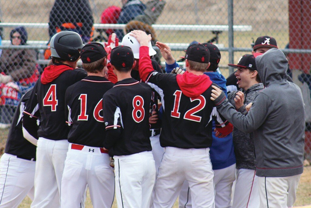 Hunter Zimmerly gets congratulated by the team for a first inning solo home run. Zimmerly was also brilliant on the mound in leading Amboy to a 3-0 triumph over Polo in a varsity conference baseball contest on April 2 at City Park.
Photo courtesy of Jordan Tidmore