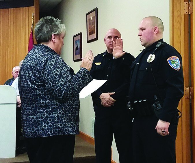 Gordon Woods / Journal
City clerk Cheryl Van Valey administers the oath to Jake Jostes as a new sergeant at Clinton Police Department while Police Chief Ben Lowers watches.  The swearing in came during Monday’s city council meeting.