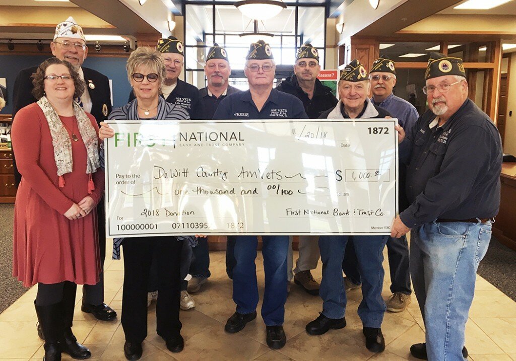 Courtesy of Clinton AMVETS
Pictured are members of the 1st National Bank staff and eight AMVETS Post 14 members at the check presentation ceremony on November 20.