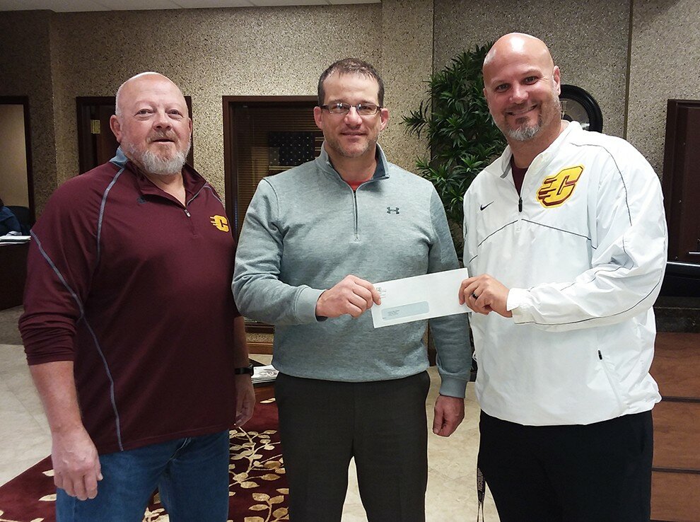 Gordon Woods / Journal
CHS softball coach Bill Barretts, left, and CHS athletic director Matt Koeppel, right, on Monday, accepted a donation from DeWItt Savings Bank president Justin Fentress.  The bank's board approved $2,800 to replace half of the fencing at softball field.  Koeppel and Barretts said the old fence was in pretty bad condition and new fencing will look better and be safer for players.