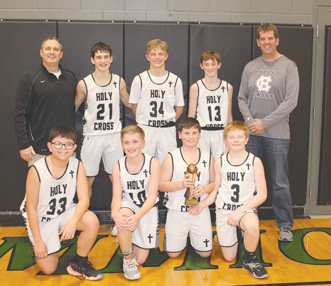 The Holy Cross seventh grade boys’ basketball team’s season ended on Feb. 3 with a 47-40 loss to Augusta Southeastern in the first round of the IESA Class 1A State Tournament. Members of the team, front row, left to right, are Rafa Arteaga, Cam Pawlowski, Liam Jones and Will Augenbaugh. Back row, head coach Aaron Eddy, Quinn Eddy, Joe Cackley, Cal Doyle and assistant coach Luke Tillman.
