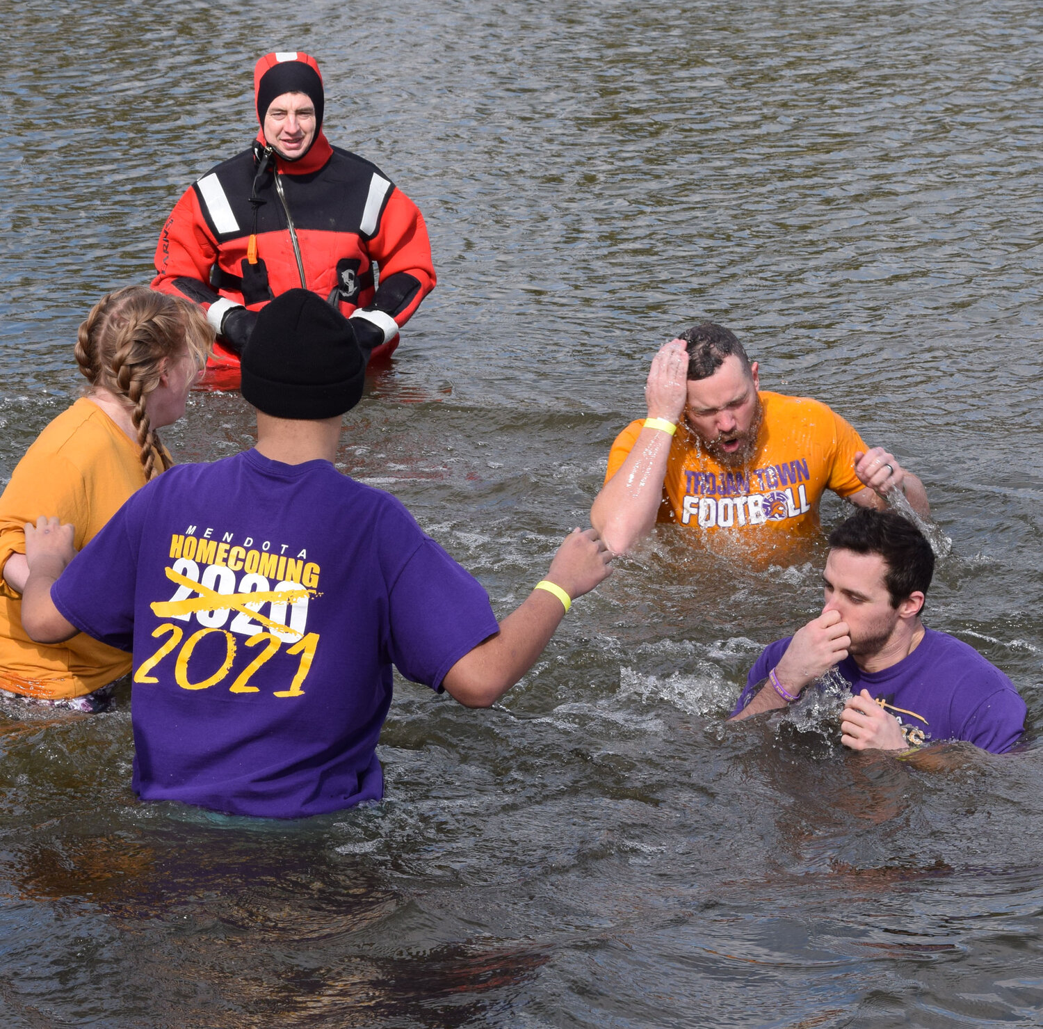 Faculty members and students from Mendota High School react to hitting the cold waters of Lake Mendota in the 2023 Polar Plunge. (Reporter photo)