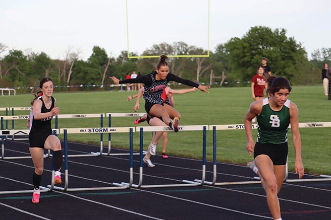 Amboy senior Elly Jones, center, qualified for the IHSA Class 1A State Meet for the fourth time. She finished third in 100-meter hurdles at the Class 1A Bureau Valley Sectional.
