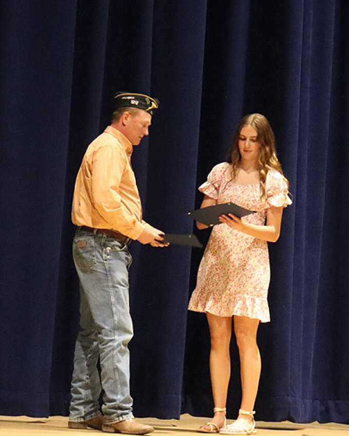 Kaitlyn Rozell receives an award from Brad Englund of Redfield American Legion.