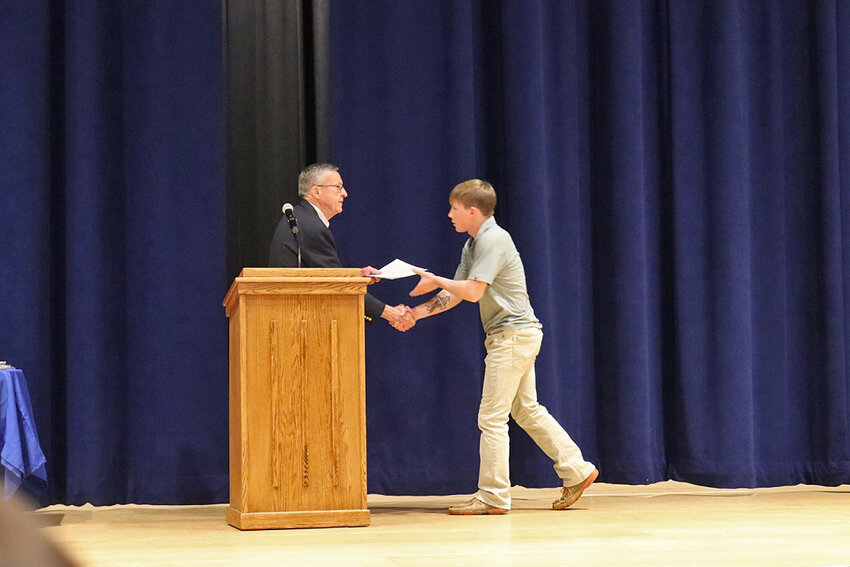Evan Jaton is presented with the Henry Baker Scholarship by Ted Williams, V.P. of Redfield School Foundation.