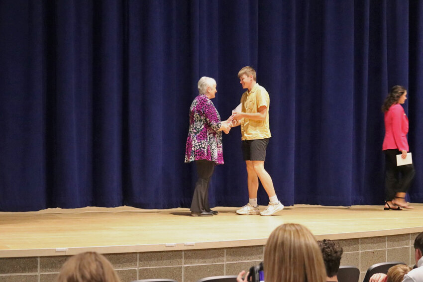 Kevin Weller is presented with a Catholic Daughters scholarship by Marlene Eimers, Regent.