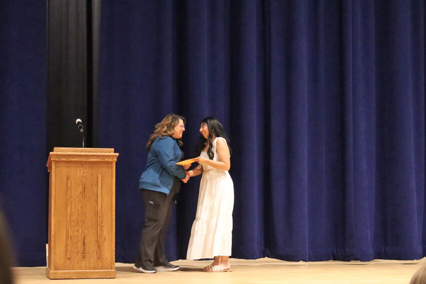 Carmen Herrera is presented with the Matthew Owens Memorial Scholarship by Debbie Bowar. Herrara plans to go into nursing.