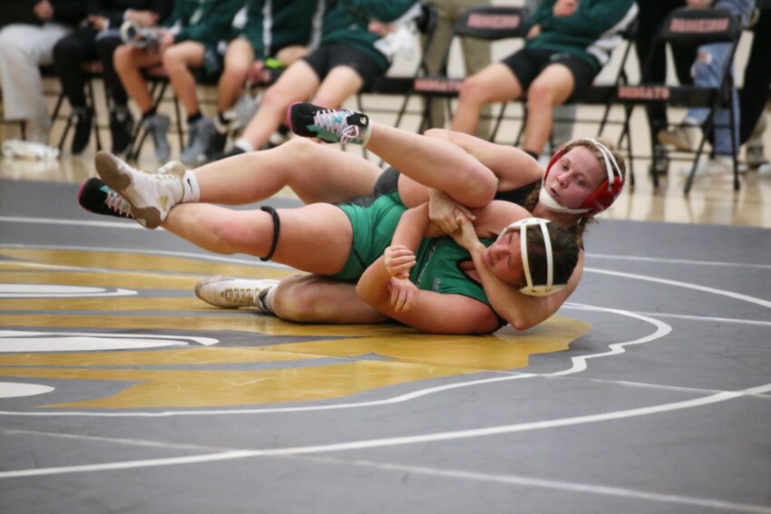 Brookings’ Maizy Mathis, top, wrestles during a dual against Pierre on Dec. 7 in Brookings. Mathis is the top seed in the 165-pound weight class in the girls state wrestling tournament at the Denny Sanford PREMIER Center in Sioux Falls this weekend.