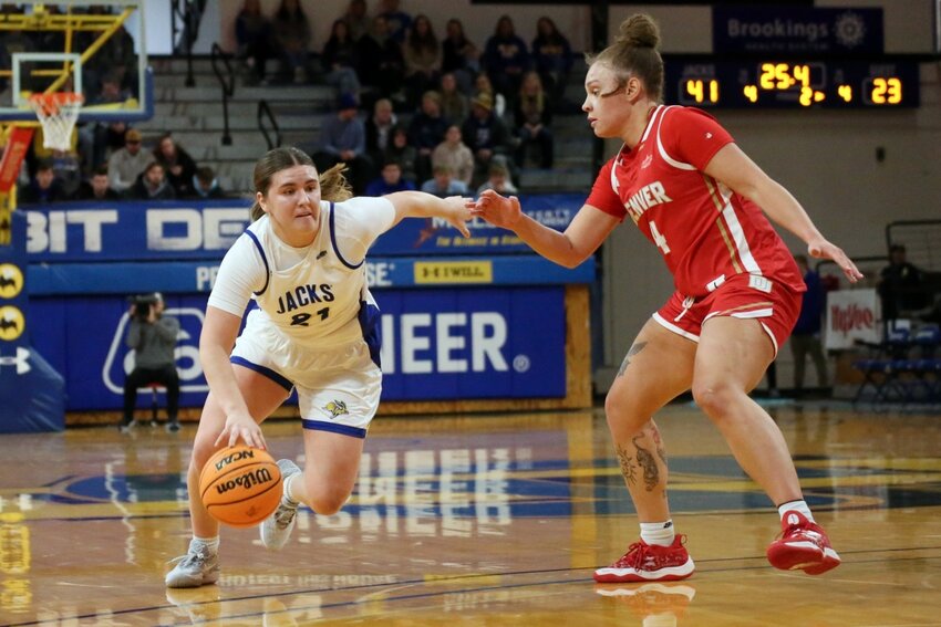 South Dakota State's Paige Meyer scored 23 points and dished out nine assists in a 97-63 win over St. Thomas on Saturday in St. Paul, Minnesota. The Jackrabbits clinched at least a share of the Summit League regular season title with the win. Here, Meyer is seen in action in a game earlier this season against Denver.