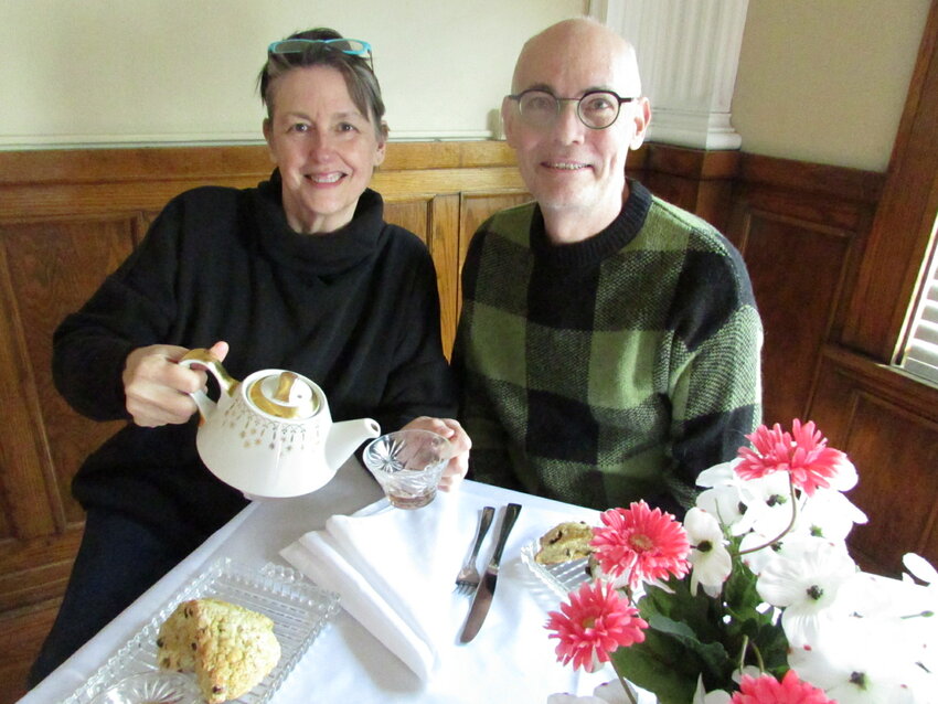 Sally Stansfield, known as the Brit Lady, pours a cup of hot tea for Brian Crabb, who will host “Tea and Scones with the Brit Lady” from 2 to 4 p.m. Saturday, April 20, at Top Floor Events.