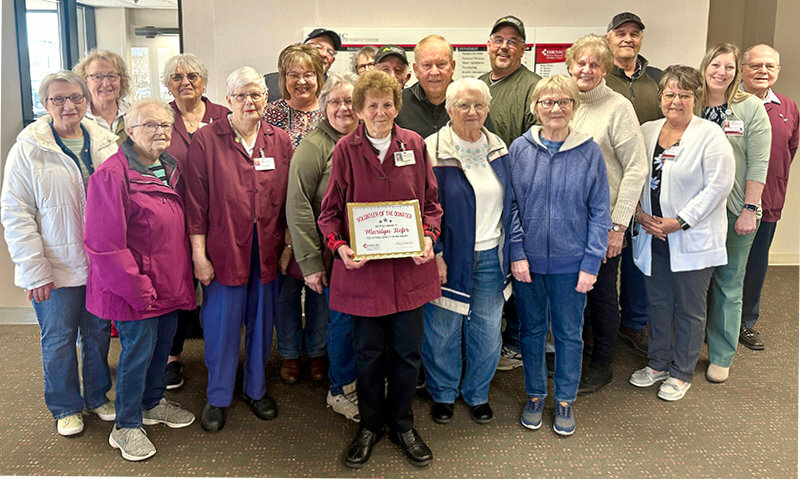 Marilyn Hofer, HRMC Auxiliary Volunteer of the Quarter, poses for a photo following her acceptance of the Volunteer of the Quarter award with fellow Auxiliary volunteers, family members, friends and HRMC leadership.