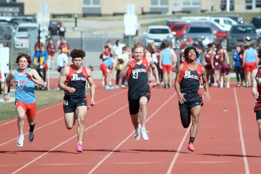 Brookings sprinters Gus Armenta, left, Gavin Anderson, center, and LaVonte Carter, right, compete in a heat for the 100 meter dash at the Brookings Athletic Complex on Monday afternoon.