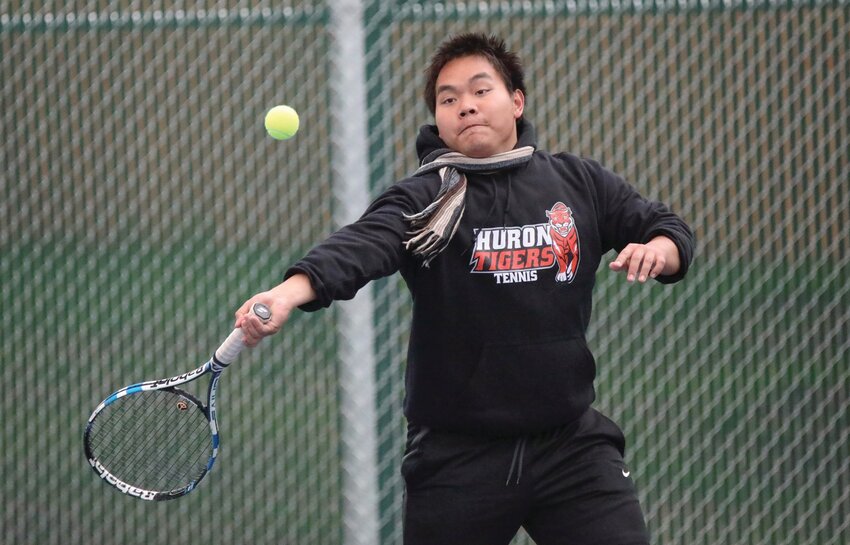 Huron’s Kmui Htoo plays a shot during a junior varsity tennis match against Pierre on Saturday at Huron Courts.