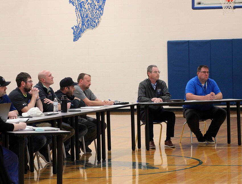 The Elkton School Board, left, and superintendent Brian Jandahl, second from right, listen to public comment Wednesday at the Elkton School gym. The board accepted the resignation of a first-grade teacher but rejected Jandahl's offer to resign as well.