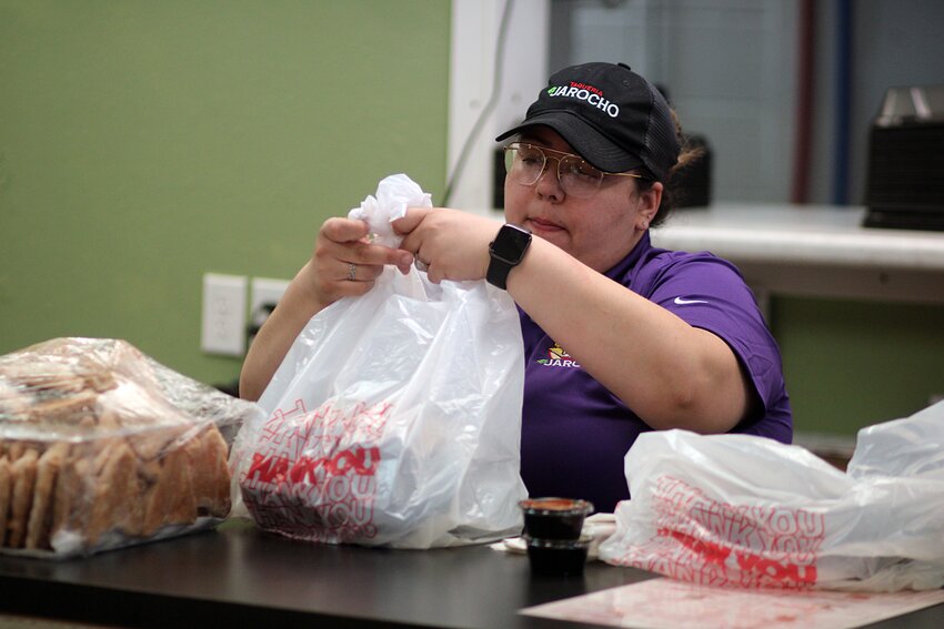 Mary Machado, the manager at Taqueria El Jarocho on 605 Main Ave., helps fill a customer’s order on Wednesday in Brookings.