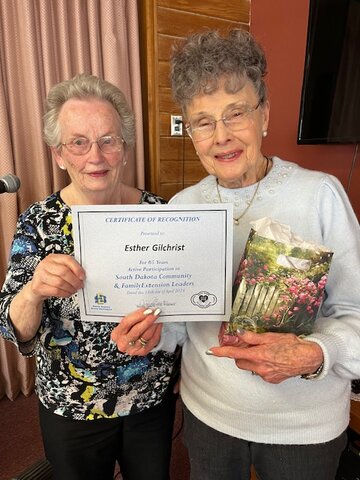 Alison Dennis, left, presents a CFEL 65-year membership award to Esther Gilchrist.